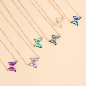 Minimalist golden necklace featuring multi-colored gradient crystal butterfly pendants