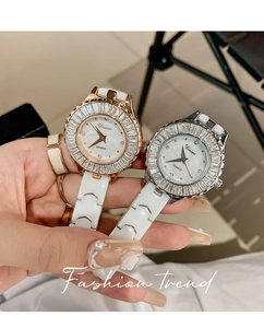 Detailed close-up of luxury ceramic watch with crystal-encrusted bezel and pearl dial