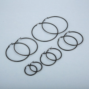 Black stainless steel hoop earrings set in five different sizes on blue background
