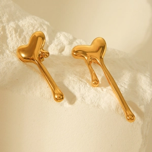 Polished 18k gold plated stainless steel fluid molten heart earrings on white rock base