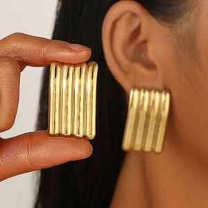 Textured gold rectangular geometric stud earrings featuring a striped metallic finish