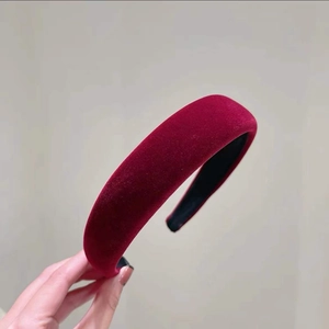 Détail du serre-tête en velours bordeaux montrant la texture douce et le design rembourré