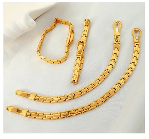 Detailed macro view of the gold-plated titanium watchband style bracelet with buckle closure