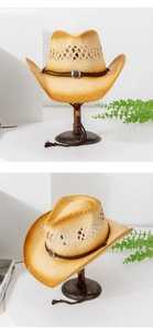 Detailed close-up of a vintage straw cowboy hat with brown cord and sun motif silver buckle