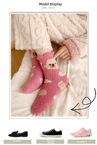 Detail of pink coral fleece thermal socks with cute cartoon bear pattern for winter