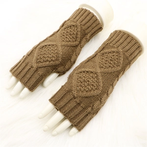 Detail of brown cable knit fingerless gloves and ribbed cuffs on white faux fur background
