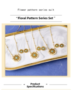 Close-up of golden floral necklaces and earrings set with turquoise stones and crystals