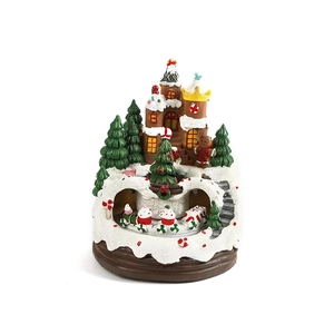 Resin gingerbread house Christmas music box with rotating train and snowy village scene