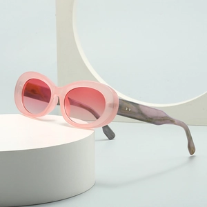 Modern oval sunglasses with translucent pink frame and marble textured temples