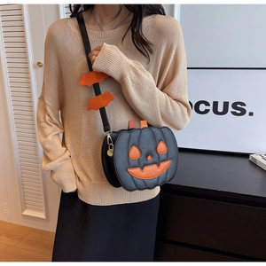 Detail of pumpkin crossbody bag with orange bat wing shoulder strap and PU leather texture