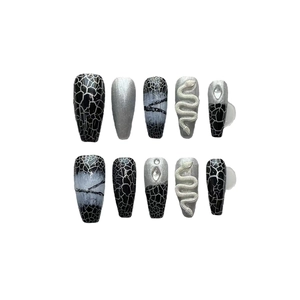Handmade black and silver snake relief press-on nails with rhinestone accents