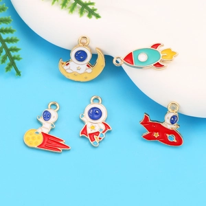 Five gold-toned enamel space charms including astronaut and rocket for DIY jewelry making