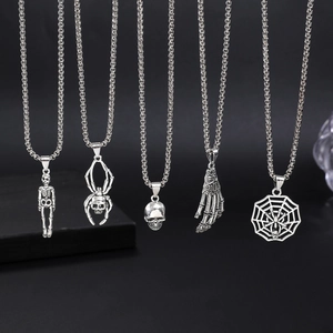 Gothic silver necklaces with spider, skull and skeleton hand pendants on black background