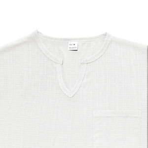 Close-up of V-neckline and chest pocket detail on white linen-like breathable shirt