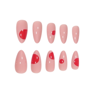 Minimalist light pink press-on nails with red dot patterns and long almond shape