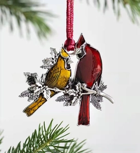 Detail showing two red cardinals on holly branches, festive enamel Christmas ornament