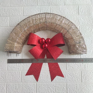 Detailed view of a 50cm Christmas wreath with red glitter bow and warm LED lights