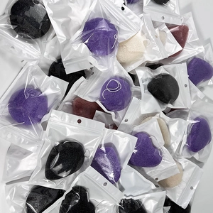 Macro detail of assorted heart-shaped konjac face sponges in clear resealable bags