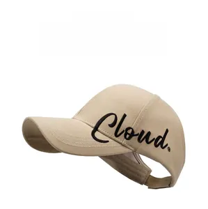 Detail of embroidered Cloud text on beige cotton ponytail visor baseball cap side