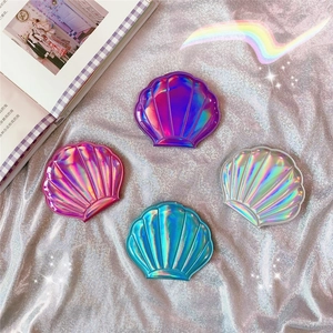 Iridescent laser shell-shaped makeup mirrors in assorted dreamy pastel colors