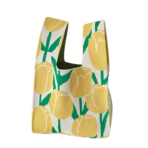 Knitted tote bag with yellow tulip floral pattern on cream white background