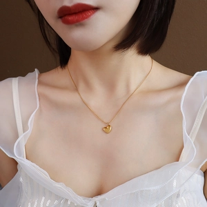 Minimalist heart pendant necklace in 18k gold plated stainless steel on model