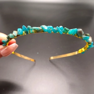 Detail of handcrafted blue natural stones hand-wrapped with gold wire on headband