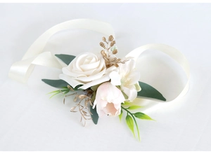 Detail of bridal wrist corsage with white rose, pink tulip, and satin ribbon ties