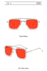 Detail of square pilot sunglasses with silver metal frame and red lenses in macro view