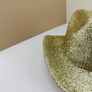Macro shot of gold sequined party hat showing reflective textures and glitter details