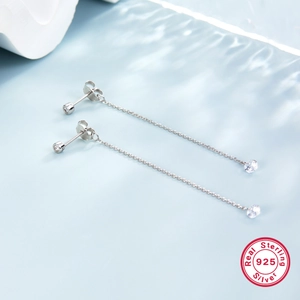 Macro shot of S925 sterling silver long tassel earrings with clear zircon on water wave