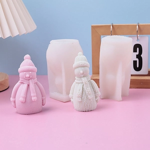 Detail view of snowman silicone molds and finished candles with knitted textures