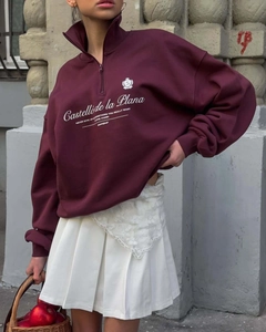 Detail of vintage burgundy half-zip sweatshirt with white chest lettering and polo collar