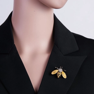 Enamel bee brooch with yellow stripes and sparkling crystals on a black suit lapel