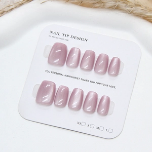 Handmade light pink cat eye press-on nails in short square shape on display card