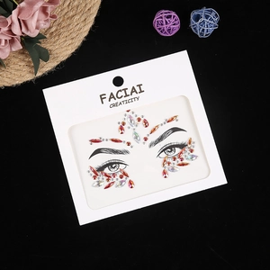 Macro shot of red and AB crystal face jewels for festival eye and forehead makeup