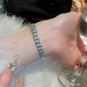 Detail of 18k gold plated geometric buckle bracelet with zircon stones on wrist