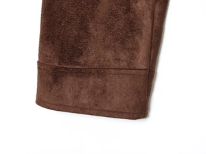 Detailed macro view of the brown suede fabric and clean stitching on the jacket cuff
