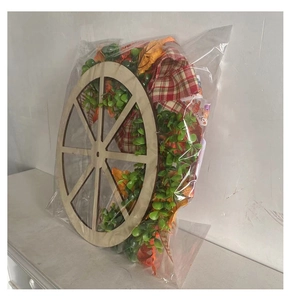 Detail of wooden wheel harvest wreath with plaid fabric in plastic protective packaging