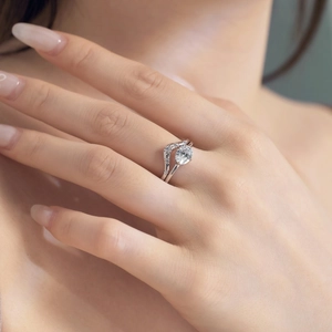Close-up of S925 sterling silver bridal ring set with oval-cut stone on hand