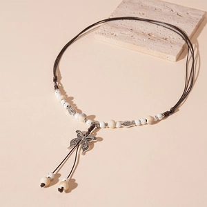 Ethnic bohemian long necklace featuring a metal butterfly pendant and ceramic beads