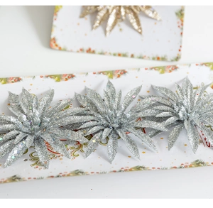 Detailed view of artificial Christmas flowers with glitter finish in silver and gold colors