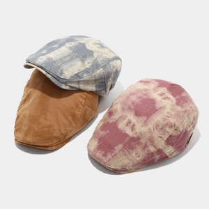 Detailed shot of retro flat caps in solid khaki and blue pink tie-dye cotton canvas