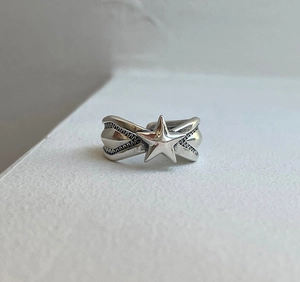 Macro shot of 925 silver star ring featuring vintage textures and open adjustable band