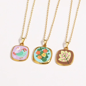 Three vintage gold-plated necklaces with colorful enamel evil eye and floral pendants