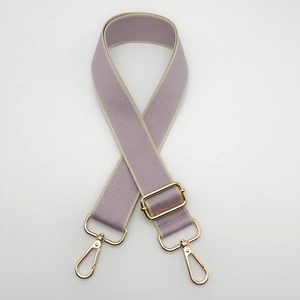 Close-up of adjustable light purple woven shoulder strap with gold metal hooks and buckle