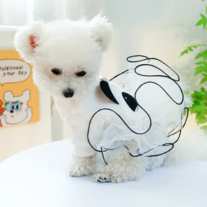 Close-up of white knitted pet dress with mesh detail on a small dog model