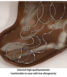 Detail of silver multi-layer stainless steel hand chains with high-quality beads and links