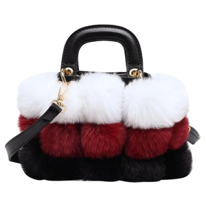 Detail of color-block plush handbag showing white, burgundy, and black faux fur textures
