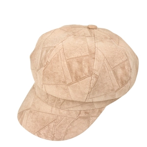 Detail view of khaki suede patchwork newsboy cap with geometric stitching and retro style